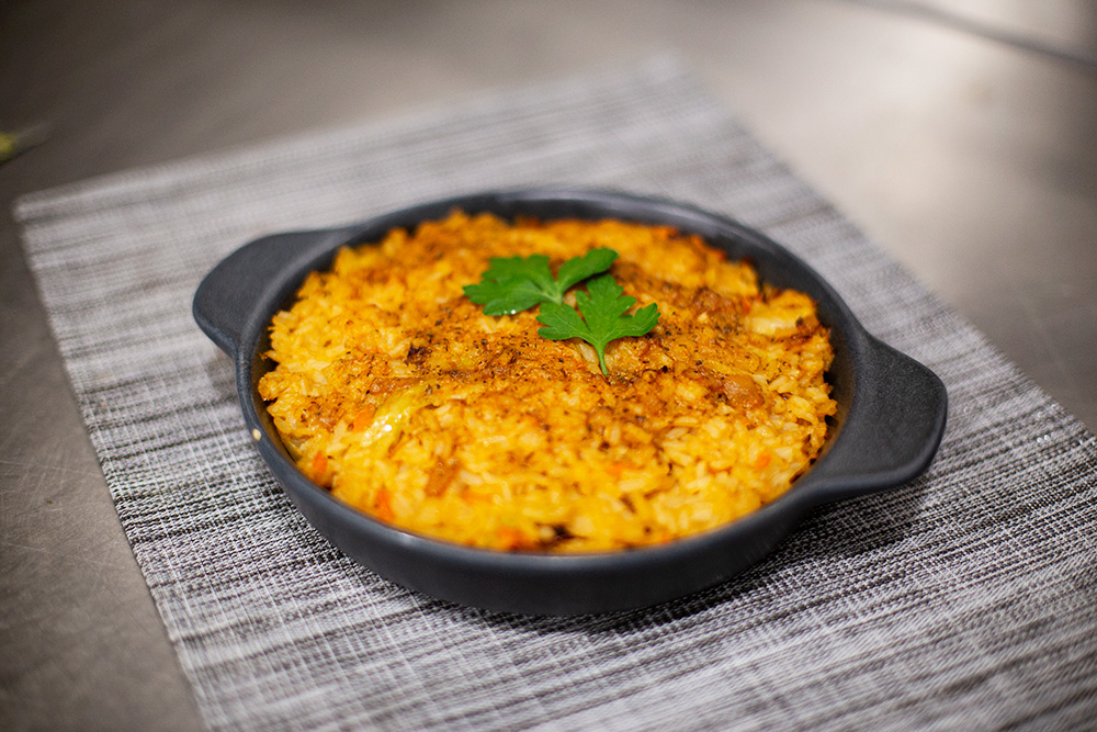 Spagheti with pesto sauce rolled on a fork